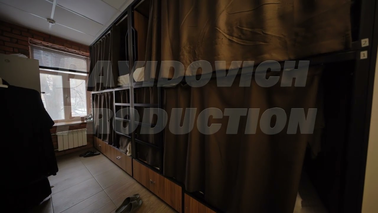 Hostel room interior showing bunk beds with curtains ensuring privacy