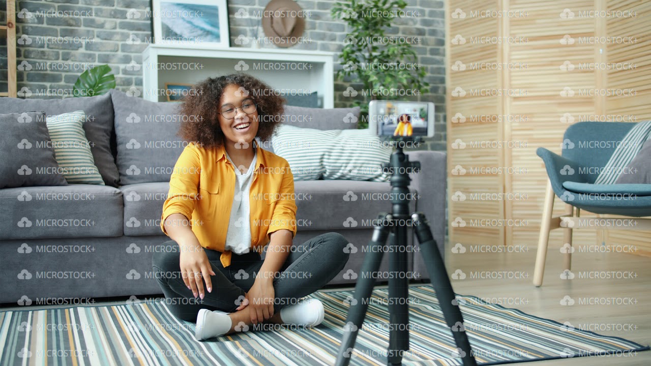 African American girl blogger recording video for internet vlog using smartphone