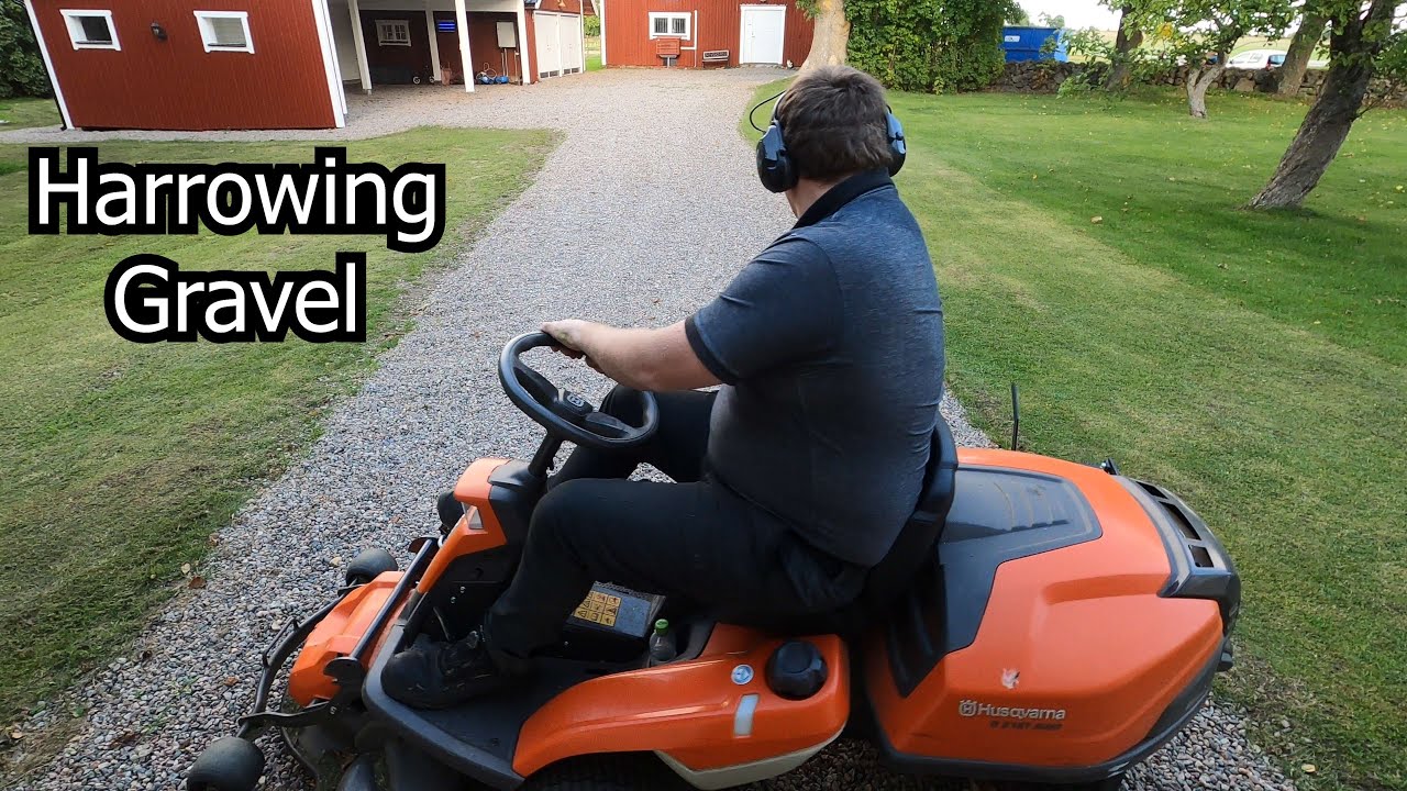 Harrowing our gravel driveway with my lawnmower