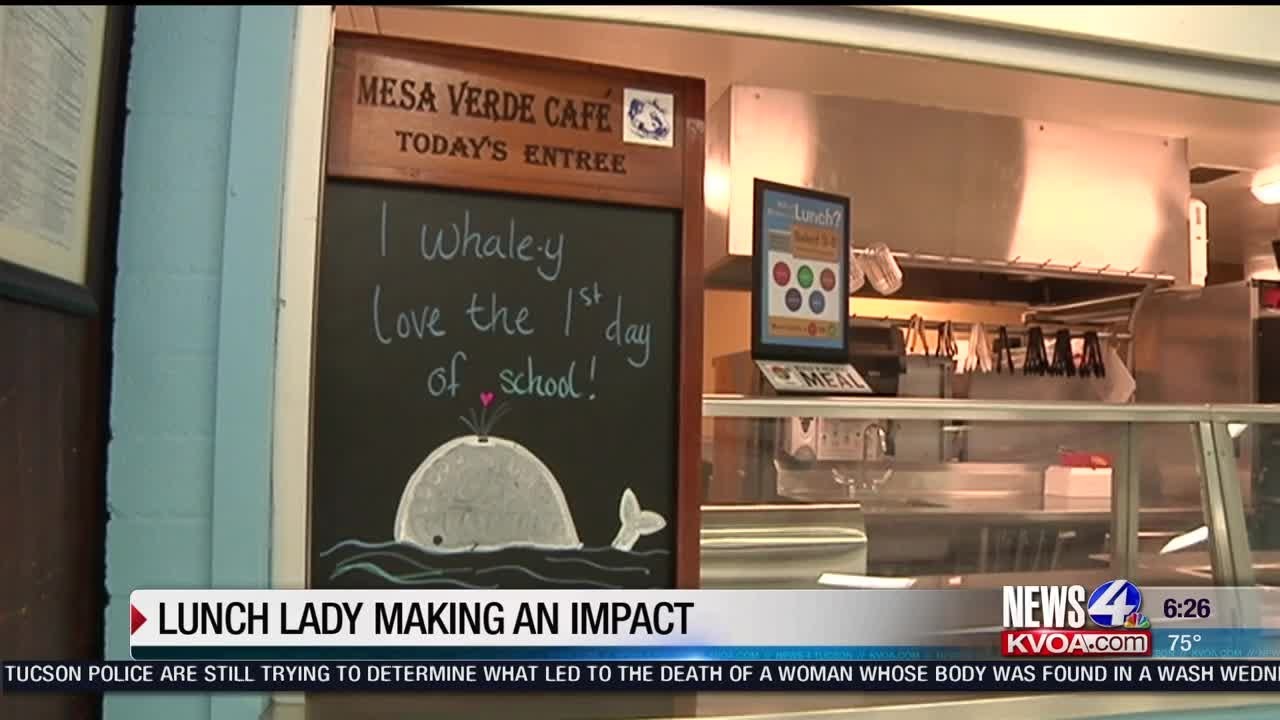 School cafeteria worker making signs