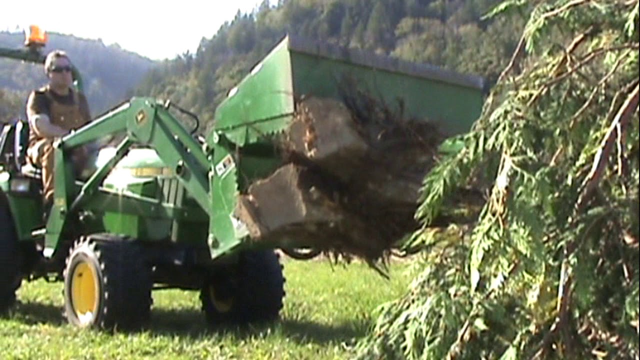 John Deere Tractor With 4 in 1 Bucket Used To Move Stumps