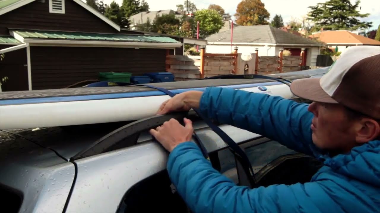 How to Tie a Surfboard or SUP to a Car with roof rails and a yoga mat.