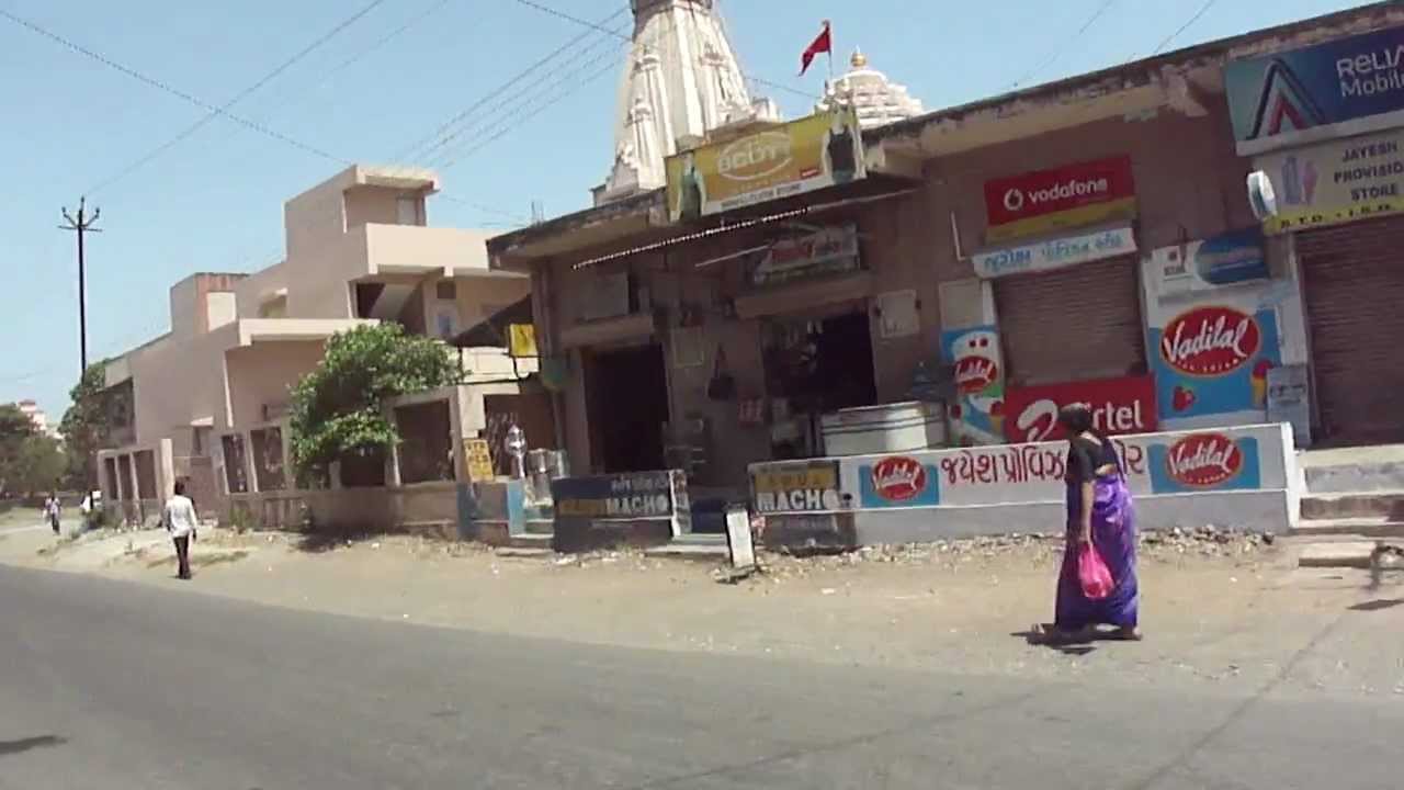 Riding a scooter around Sisodra village, Navsari, Gujarat, India; 25th May 2012