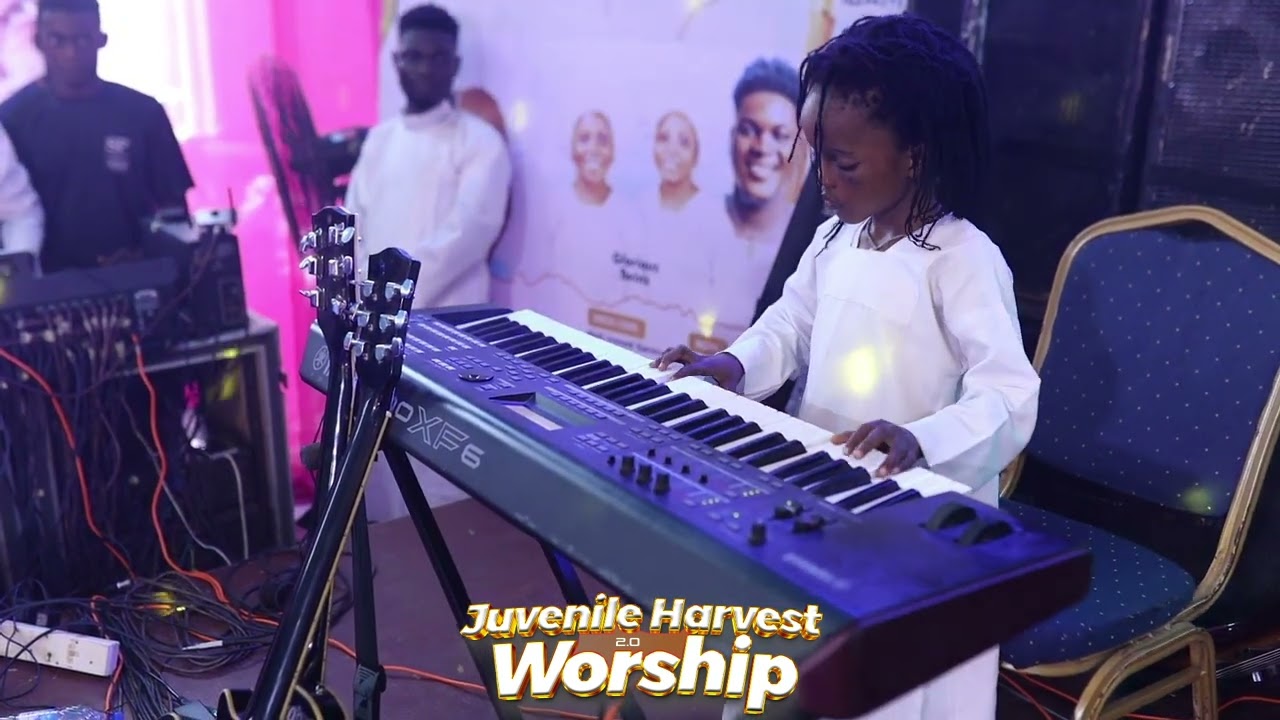 Little Boy playing keyboard at Juvenile Harvest worship with Bola Halleluyah  2.0