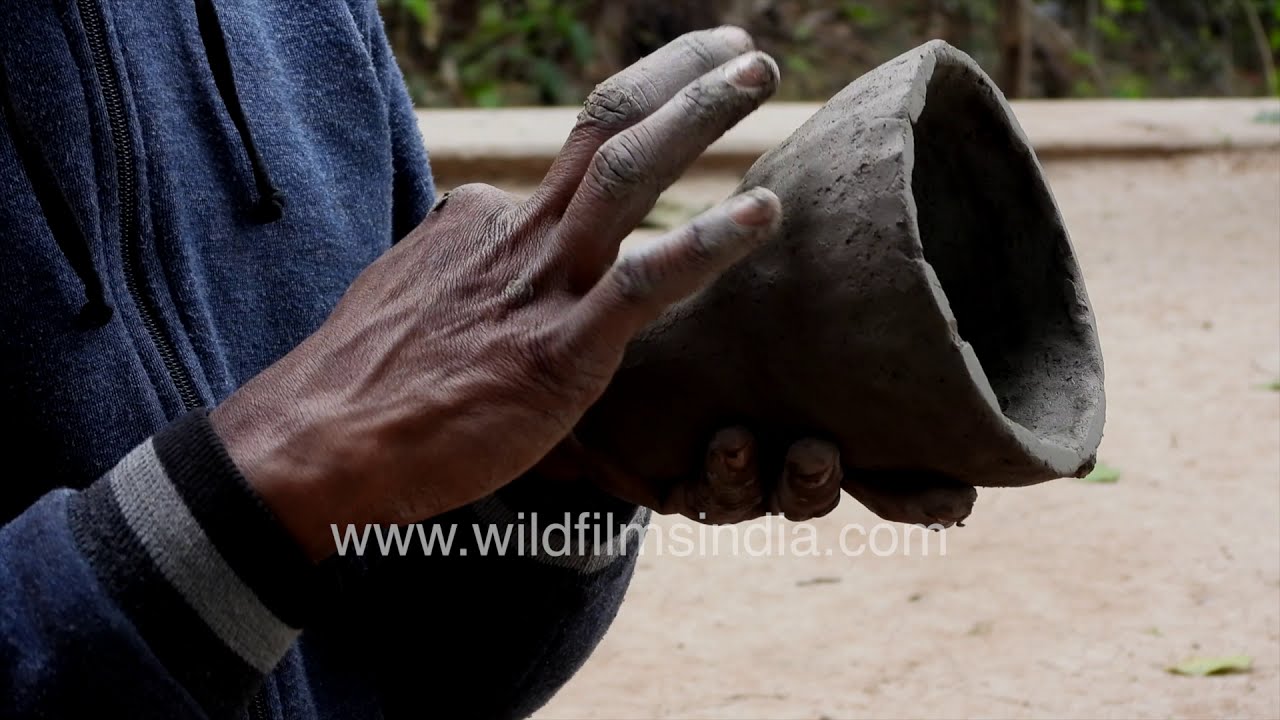 Potter at work in rural India: kumhar shapes, prepares baked mud objects and bowls, then bakes them