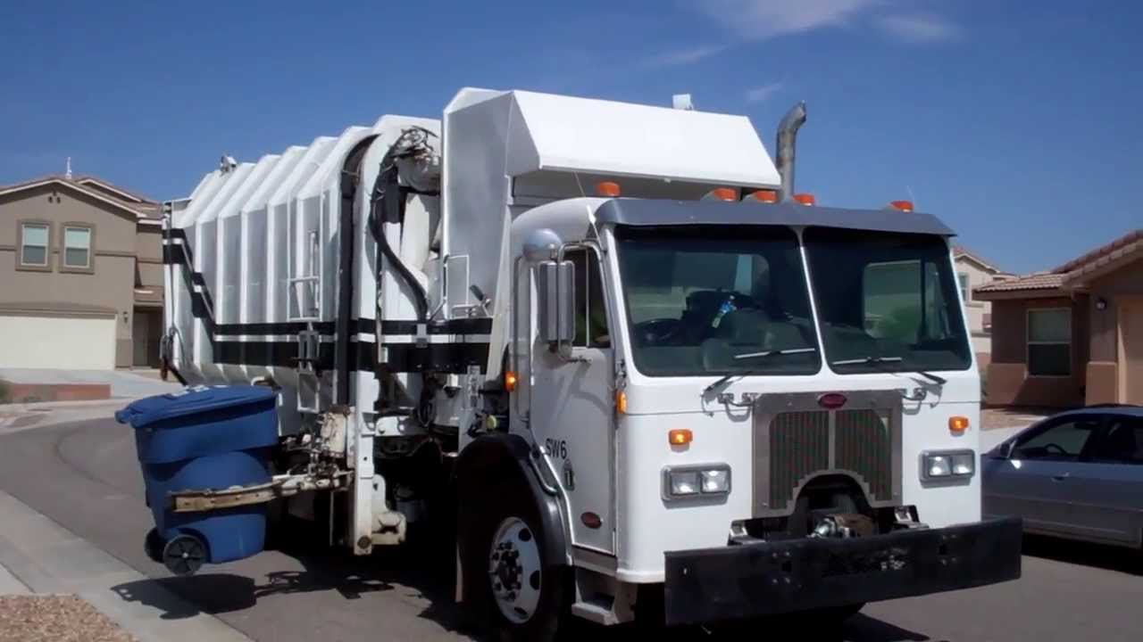 Los Lunas Solid Waste - Peterbilt 320 single axle Amrep Octo dumping Roto's and M-Series