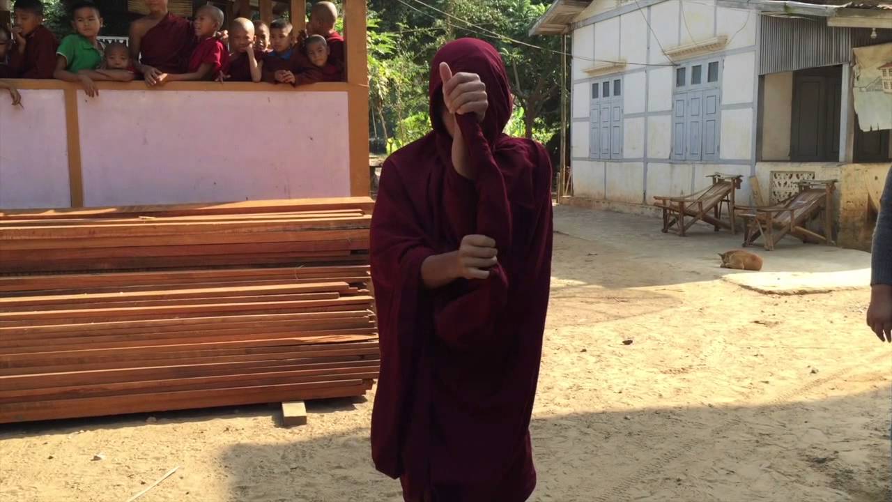 Monk Wrapping His Robe for Alms Collecting in Myanmar | SmarterTravel