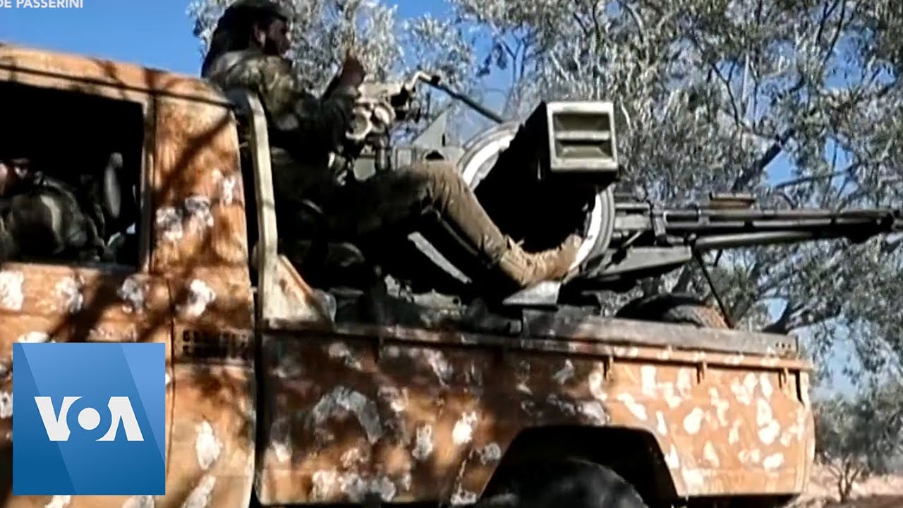 Syrian Rebel Fighters Fire at Government Forces in Idlib