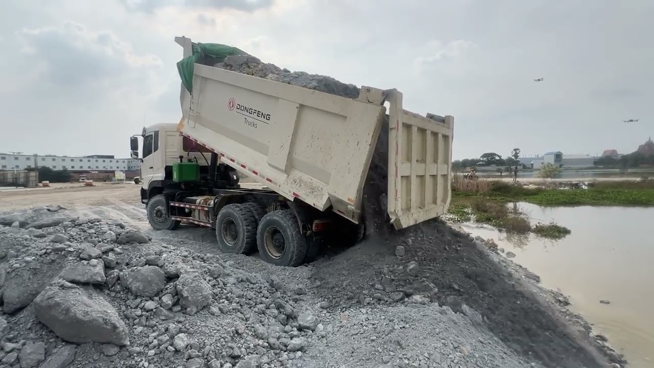 Great job heavy dump truck wheel 10 unloading stone landfill and SHANTUI bulldozer pushing stone 