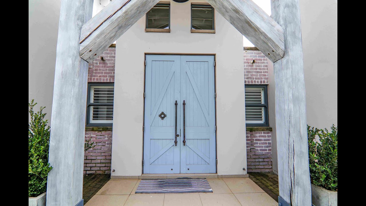 Step inside this luxurious French country masterpiece on a serene green belt!