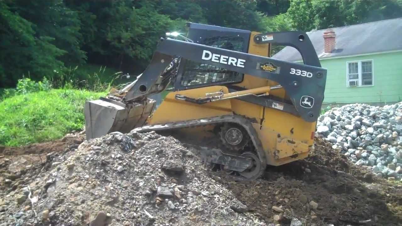 Deere 333D moving dirt.