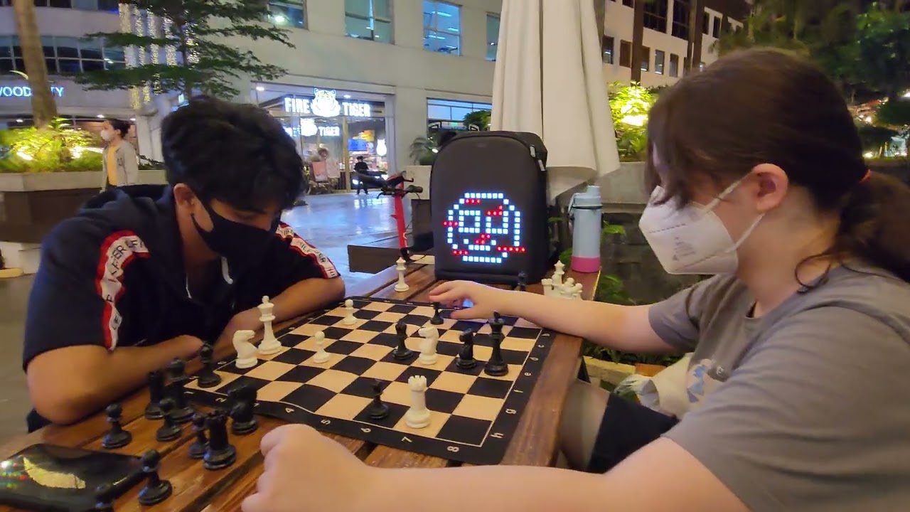 Jonel playing chess at the park
