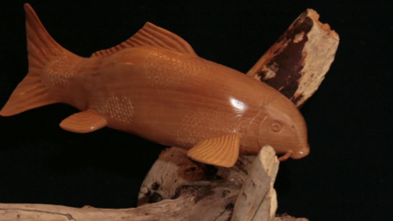 Carving a Koi out of a block of wood.