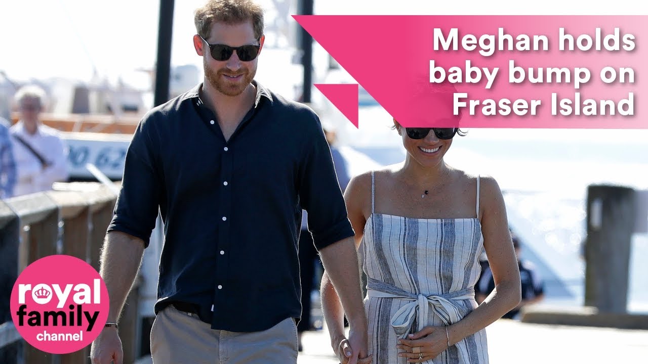 Meghan holds baby bump while walking hand in hand with Prince Harry on Fraser Island