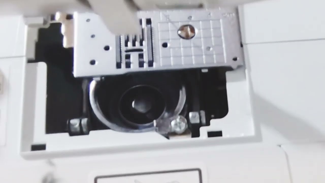 Sewing for Beginners: Remove the bobbin case and clean the bobbin housing.