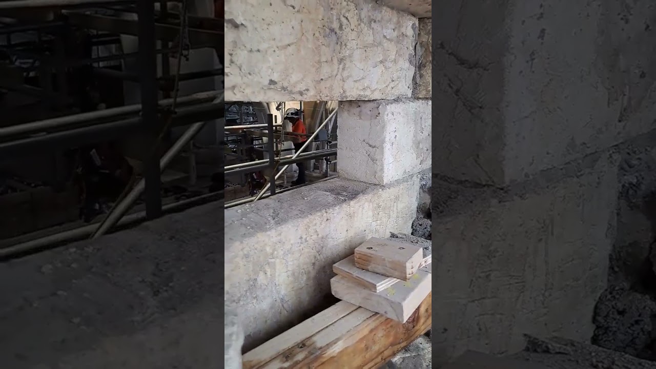 taking down ashlar in a stone church to build a share wall