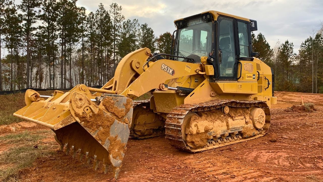 Grading a pond with a Cat 953
