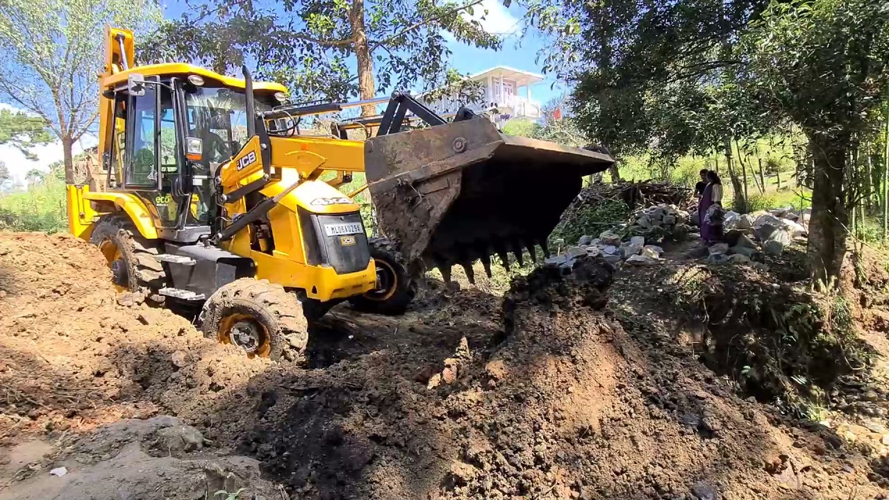 jcb filling a wall with a soil