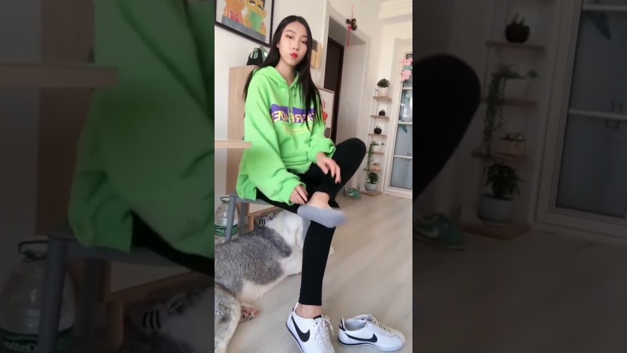 Girl takes off her shoes to show smelly socks
