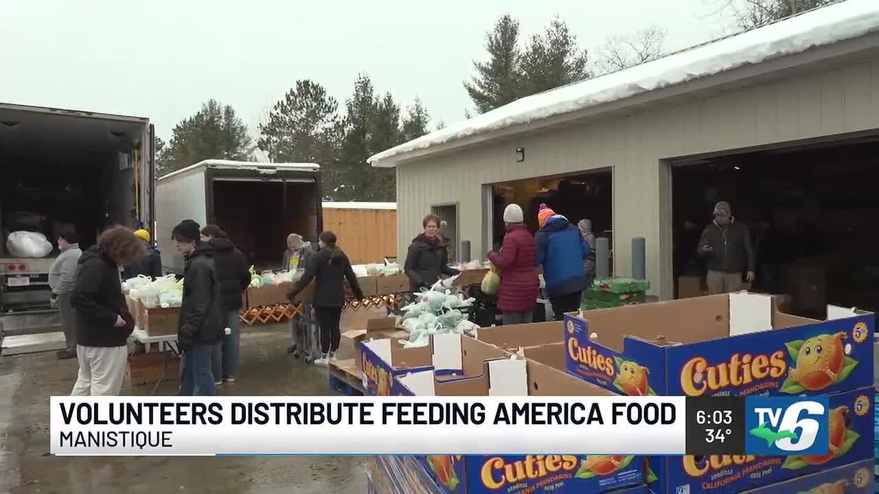 Volunteers distribute food from Feeding America truck in Manistique