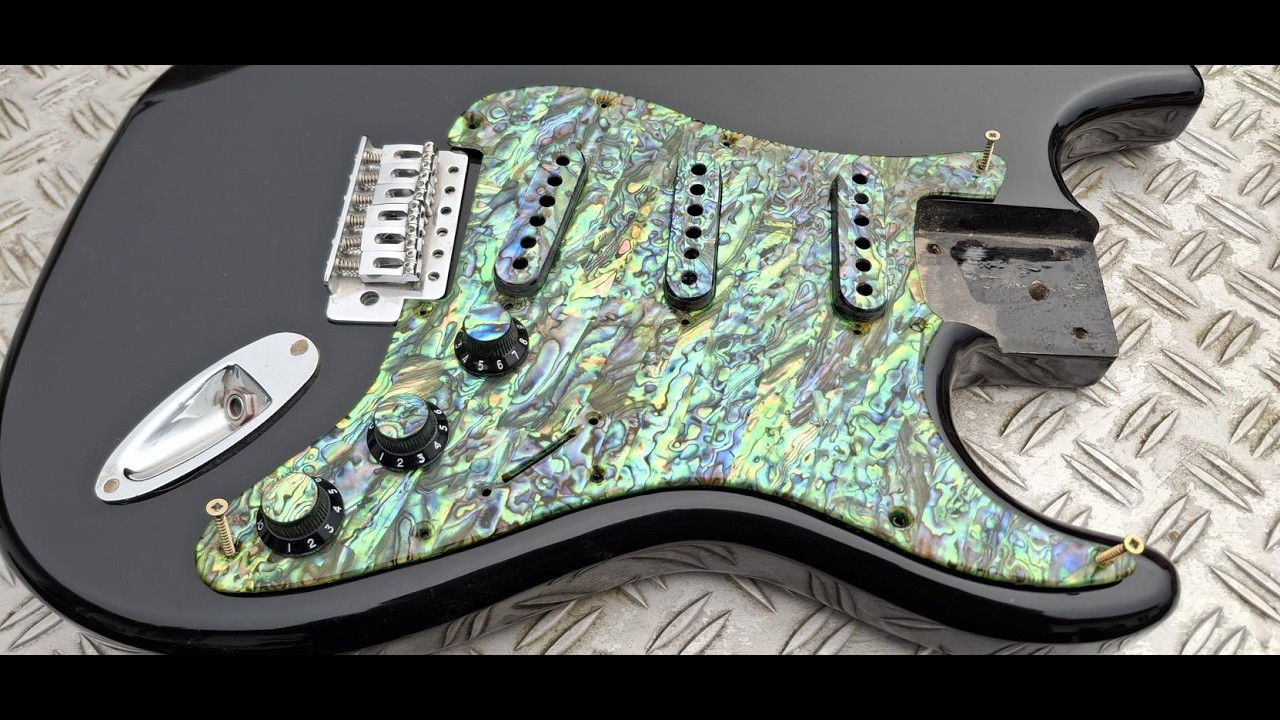 Strat pickguard up real close, stunning green Paua abalone by Pearlvibe...the colors are amazing