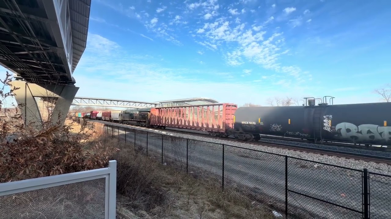 A lot of planes and 2 trains at Potomac Yard Metro station.