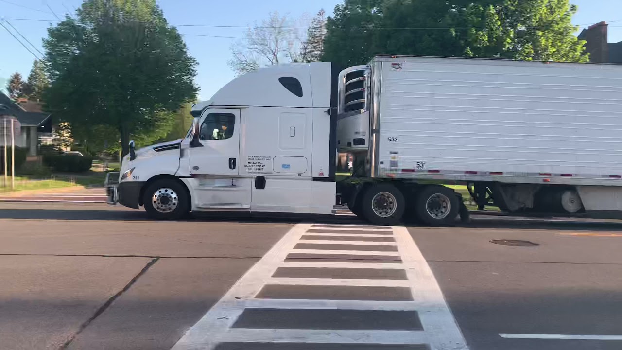 Freightliner pulling a refrigerated trailer