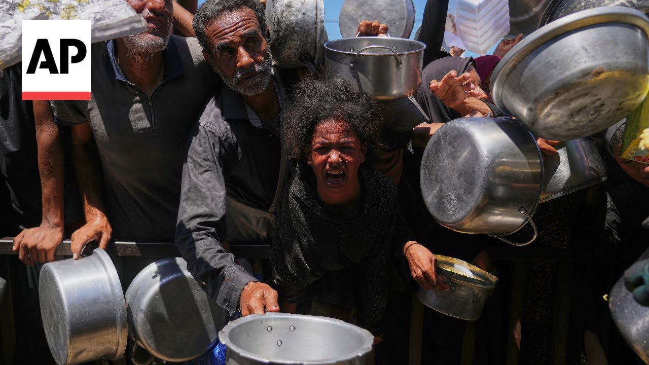 Hungry Palestinians crowd around a soup kitchen in Khan Younis for food