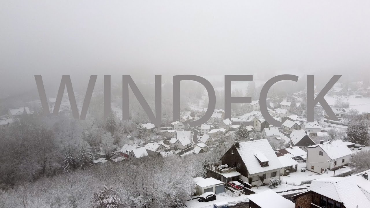 DJI Mavic Mini flying over snow-covered German village / WINDECK