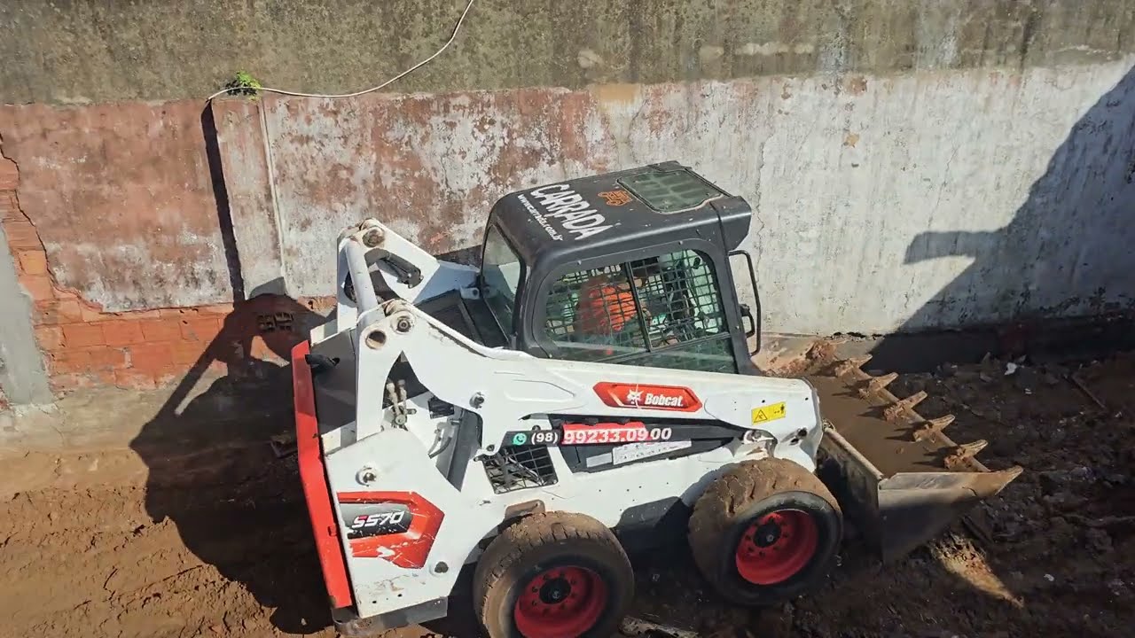 Retirando entulho, em construção apertada, com BobCat