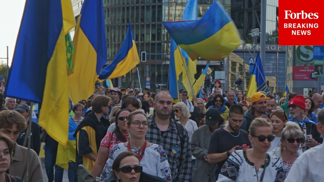 Germans Wave Flags To Demand End To Russia-Ukraine War And Celebrate Ukrainian Independence