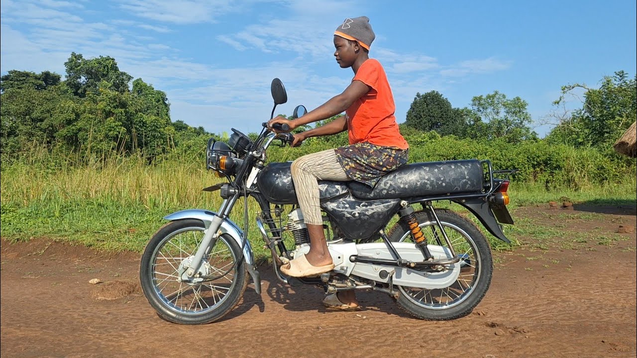 Kick start video // learning how to ride a motorcycle //  African village life