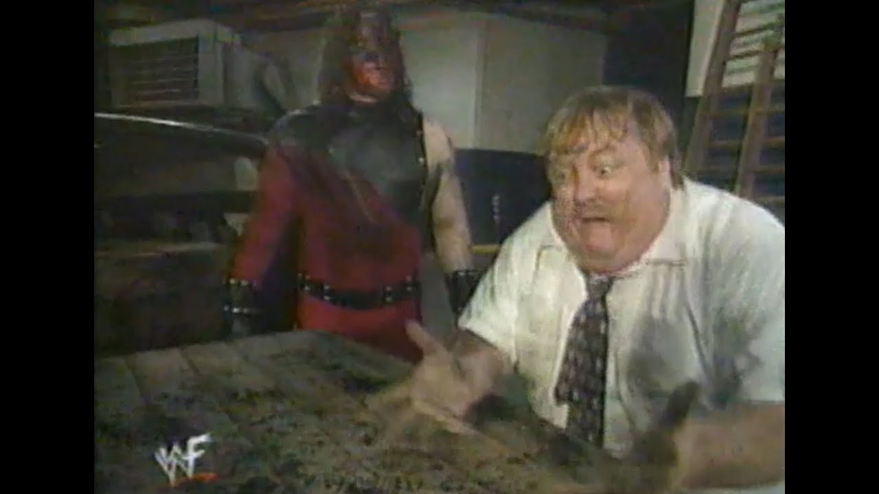 Paul Bearer and Kane dig up The Undertaker's parents (WWF)