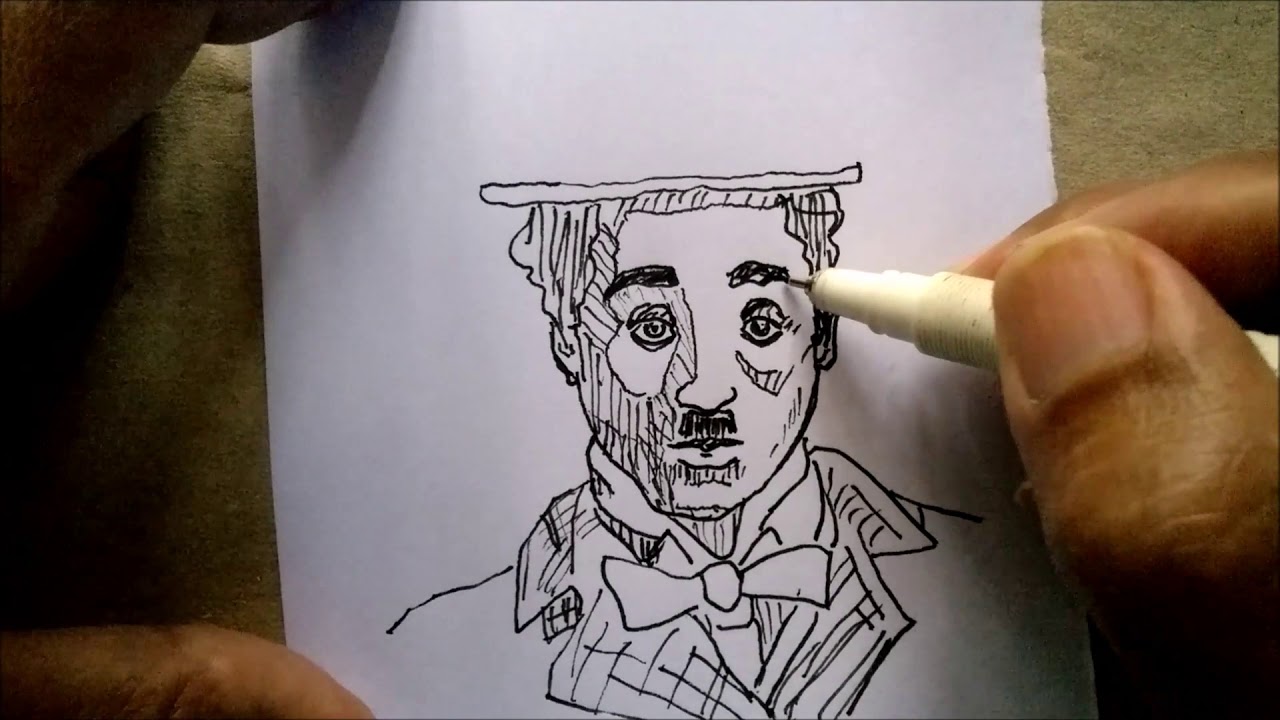 Draw a sketch of charlie chaplin's face with a pen