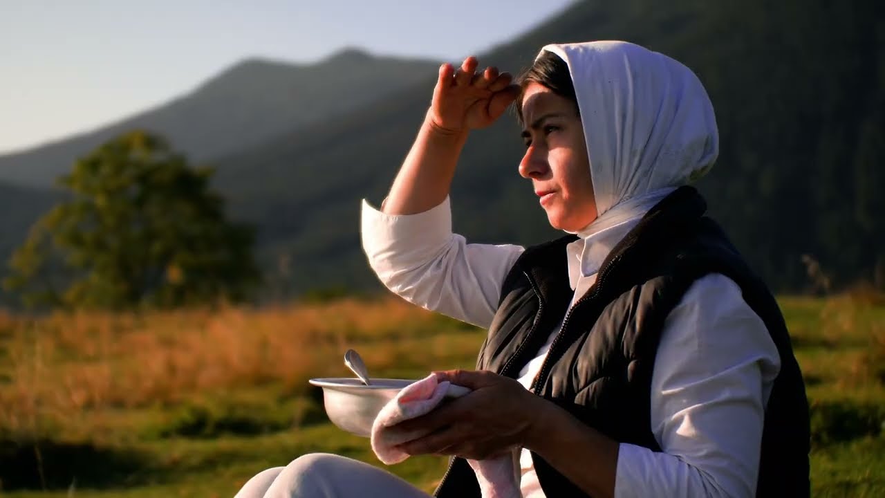 A woman is alone in the mountains. Cooking dinner and breakfast. Bushcraft camping