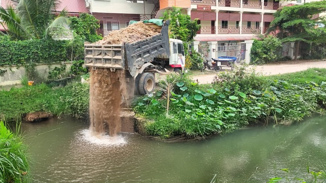 Dump Truck Unleashes Massive Load of Dirt into Pristine River Waterway: Environmental Impact