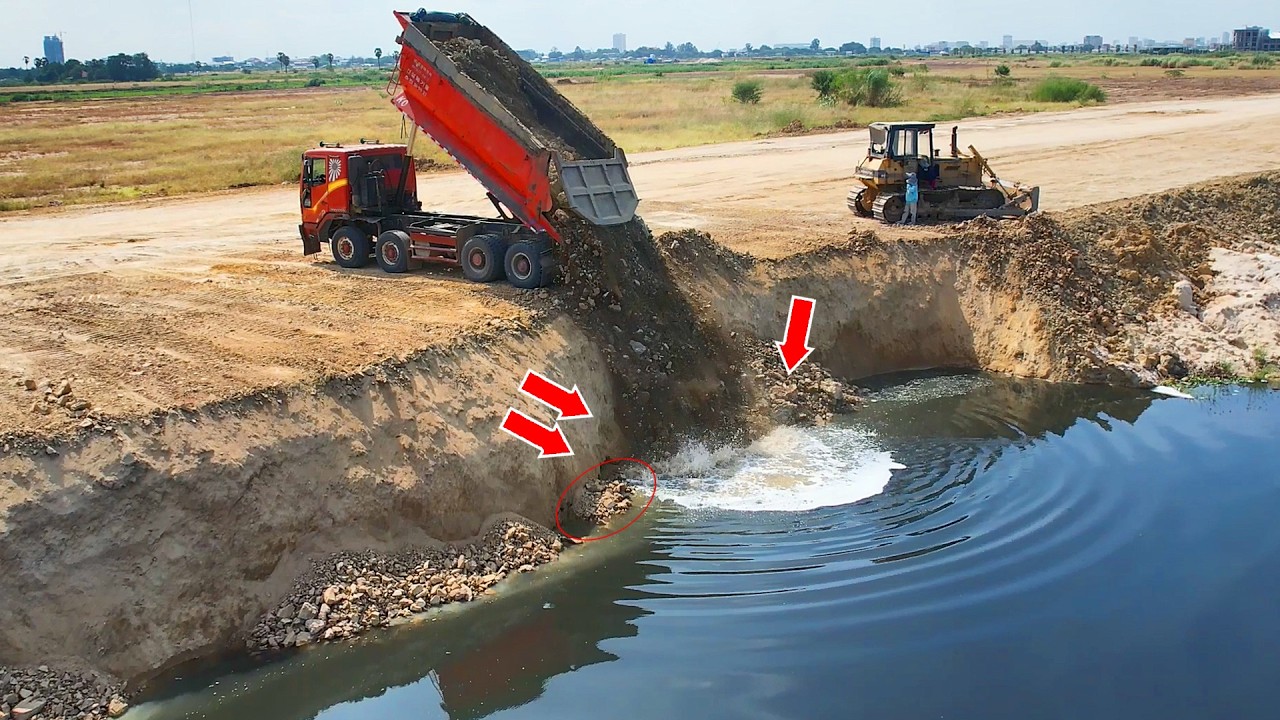 Incredible. extreme caution by KOMATSU Dozer experts pushing rocks into deep lake to build new road