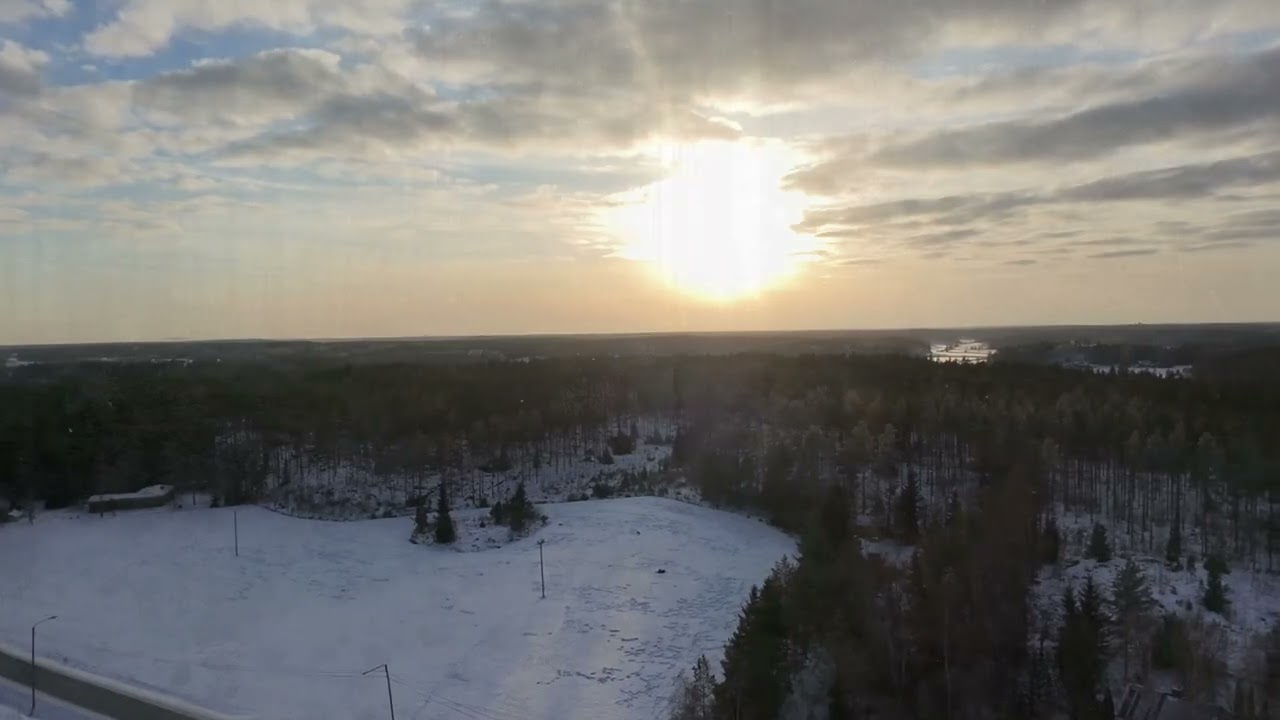Droning on a slow and chilly February evening, above and below tree tops. Snow winter relaxation.