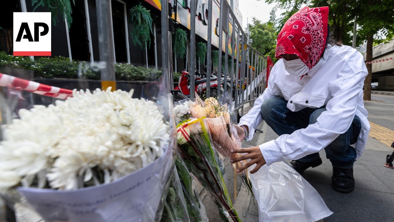 Flowers laid outside Bangkok bar after at least 27 killed in fire