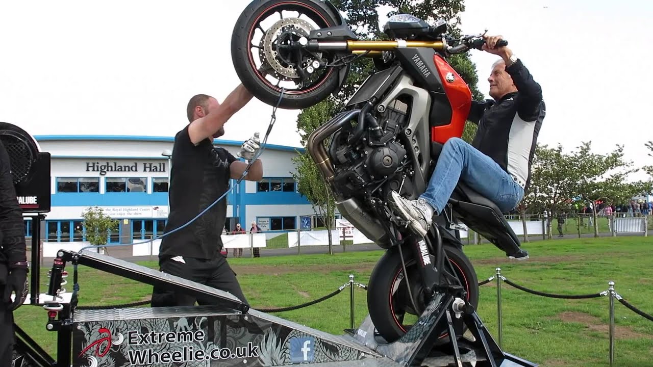 Giacomo Agostini wheelies a Yamaha MT-09