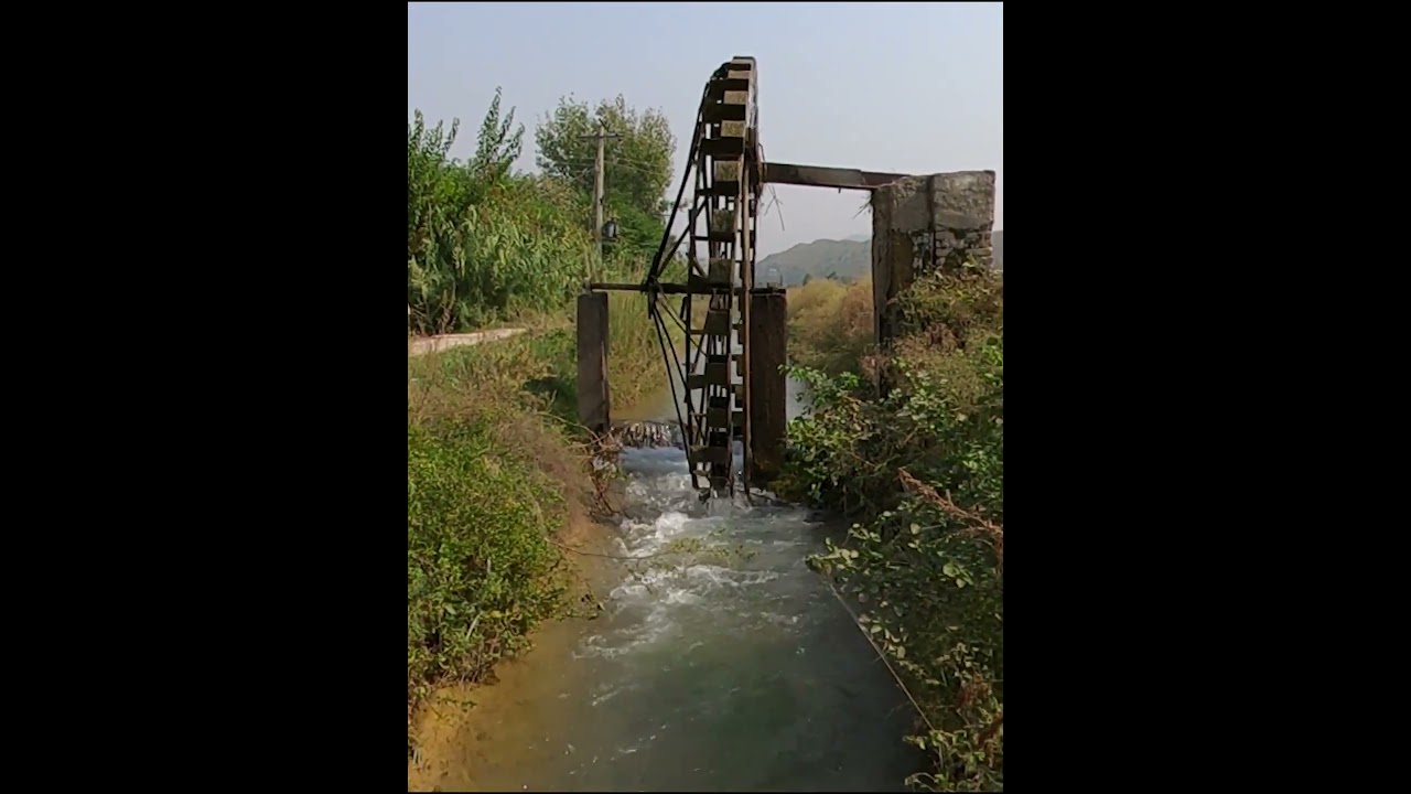 "A Glimpse into Rural Life: Ancient Water Mill in Action"