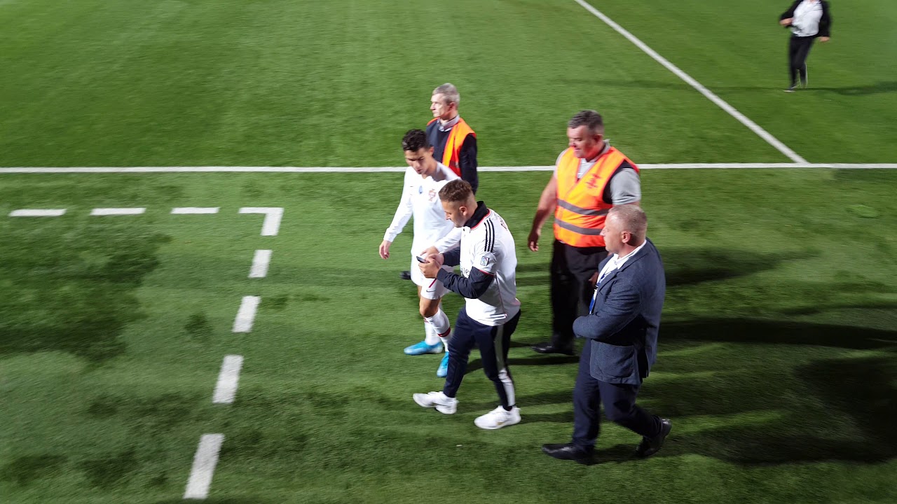 Pitch invader tries to make selfie with Cristiano Ronaldo in Vilnius Lithuania. Ronaldo Vilniuje.