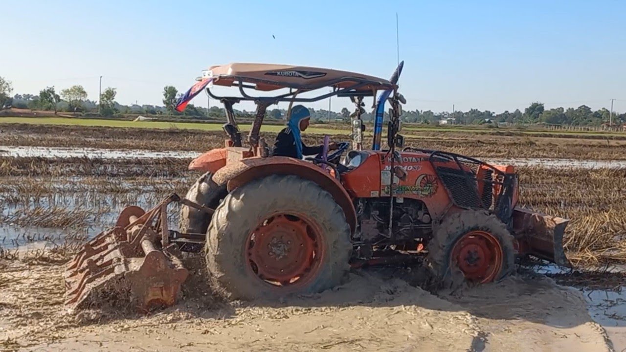 Drive Kubota Harrowing Soil Almost Stuck In Mud, Cambodia Tractor M6040SU Working Rice Field