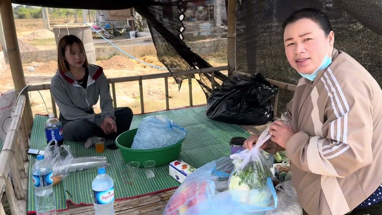 OT came from USA to married his wife in Laos.He bought land, and now he is building a fence.