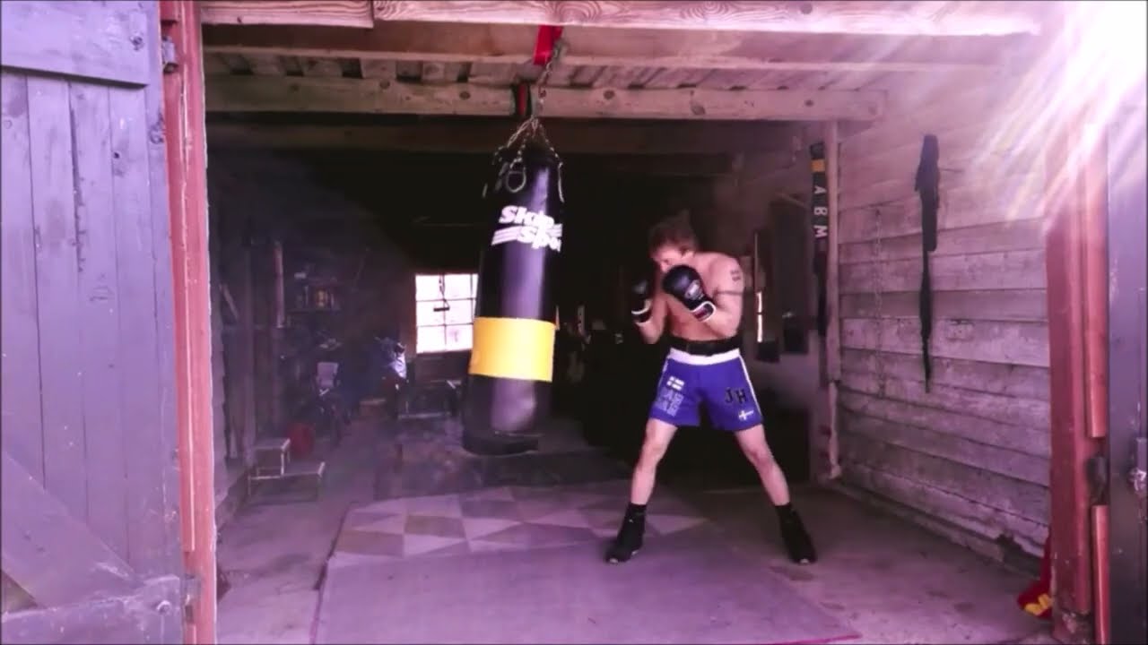 A 60 year old man punching a heavy bag