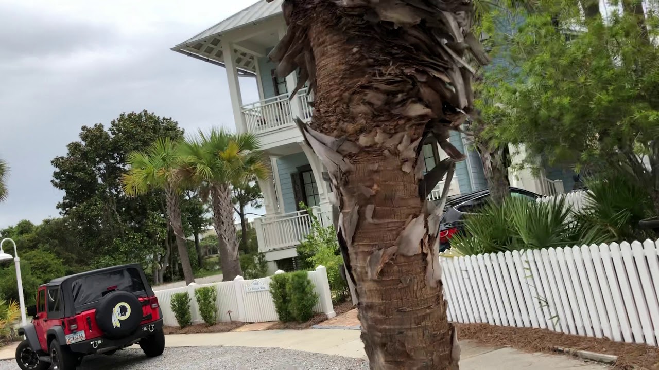 Driving golf cart through carillon beach resort community Panama City beach Florida