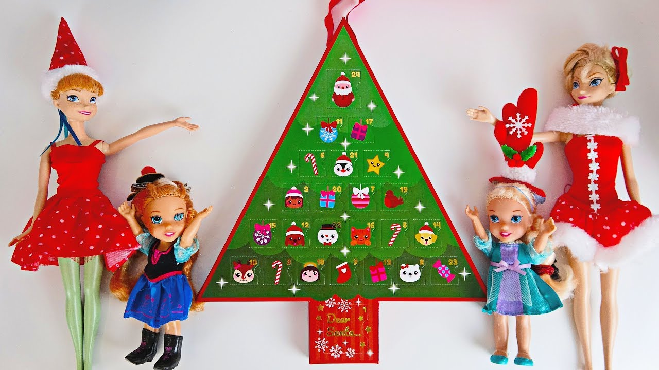 Elsa and Anna toddlers open advent calendars for Christmas