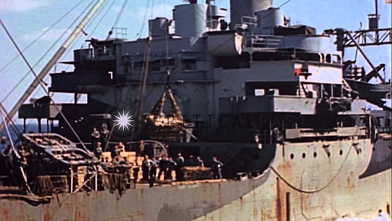 Rocket mortar crates transferred from ammunition ship to aircraft carrier at sea,...HD Stock Footage