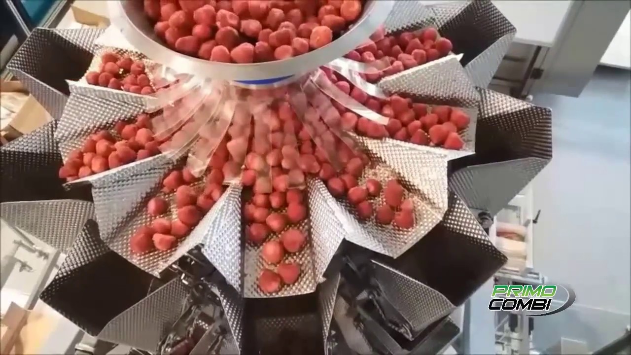 Filling frozen strawberries into stand up zippered pouches with Swifty Bagger