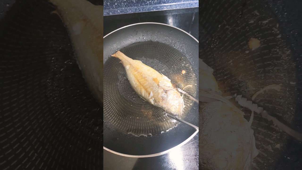 Korean mother-in-law frying Korean gulbi fish in oil. 